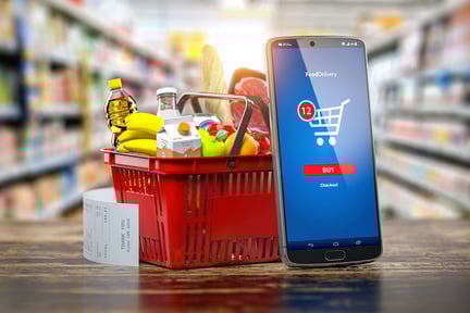 shopping-basket-with-fresh-food-and-smartphone